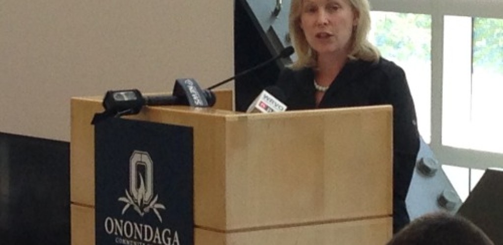 A woman speaks at a podium