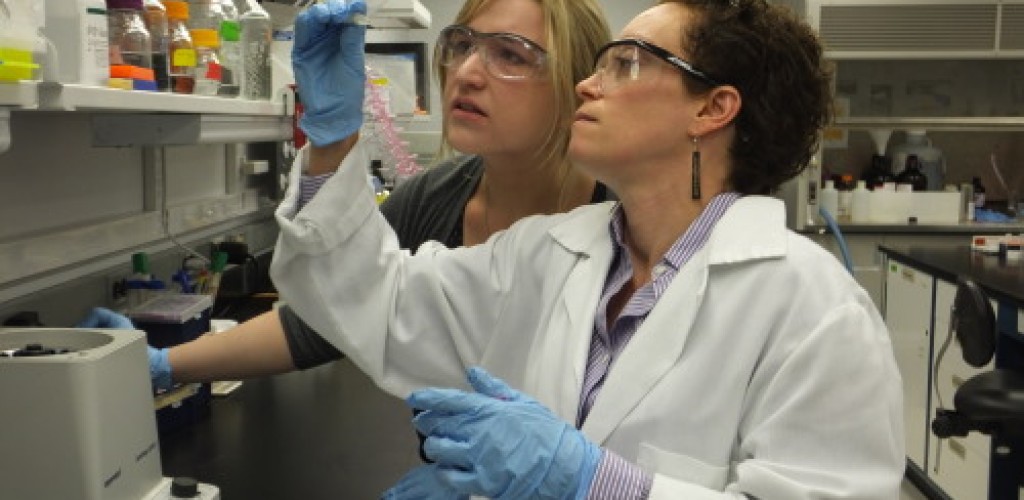 Two women examine a sample in the laboratory