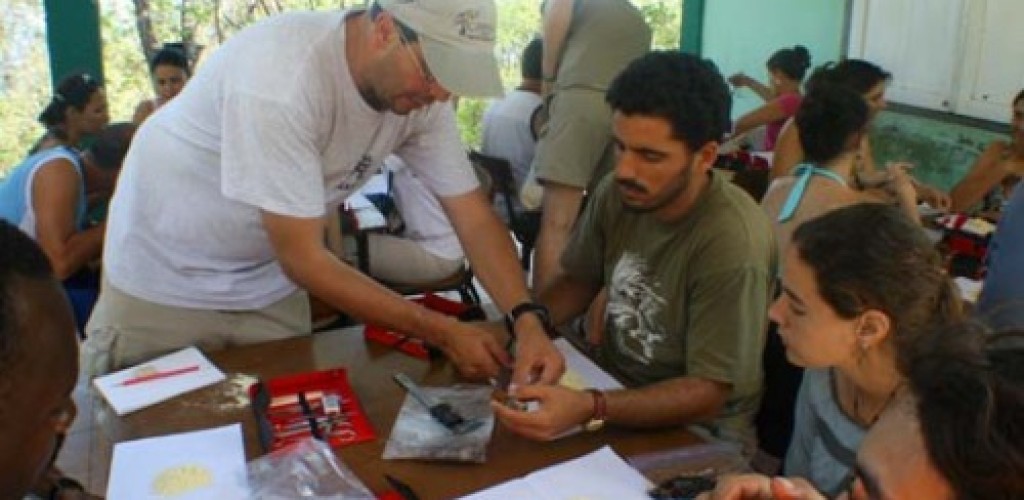 A group of people participate in specimen preparation for an ornithology class