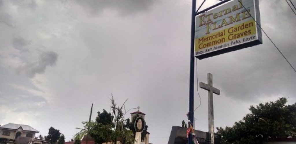 A picture of a "Memorial Garden Common Graves" sign in the Philippines