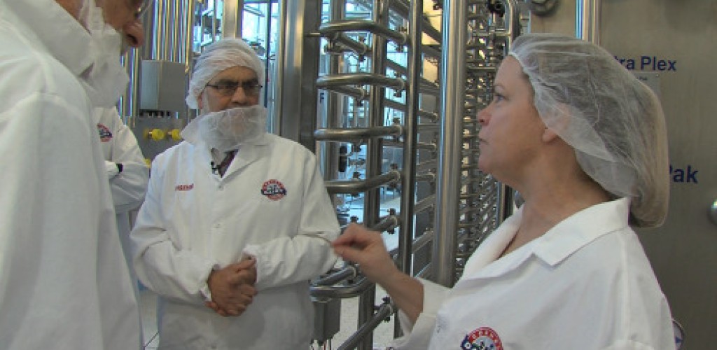 People wearing personal protective equipment in the Cornell Dairy plant