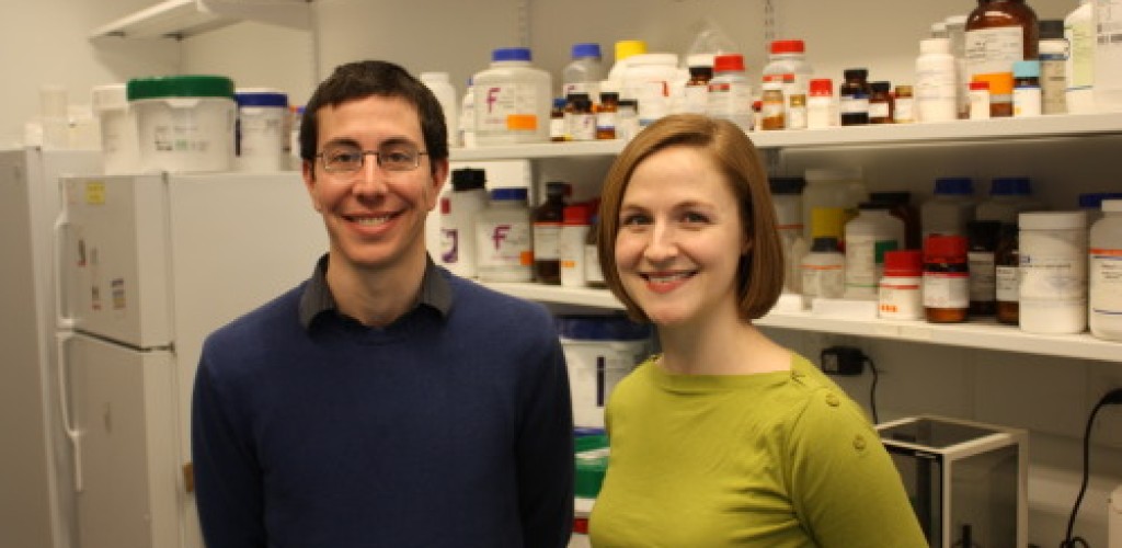 A man and a woman stand in a laboratory