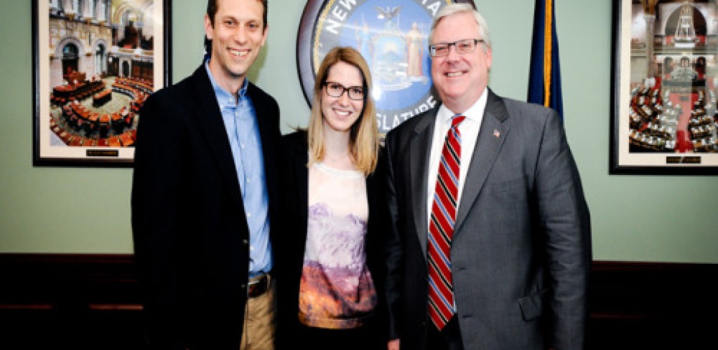 Two men and a woman pose for a picture