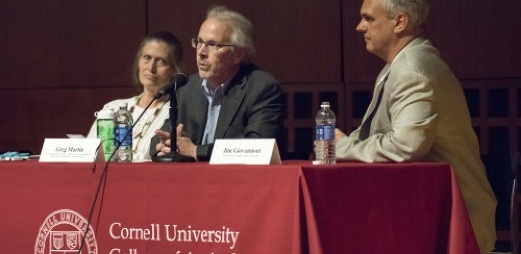 One woman and two men speak at a lecture