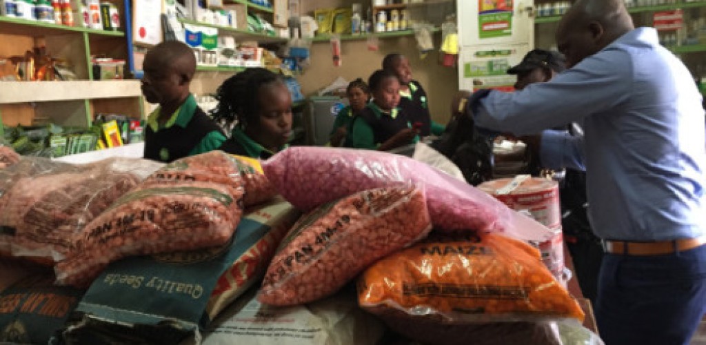 Farmers in Kenya purchase maize seed in a store