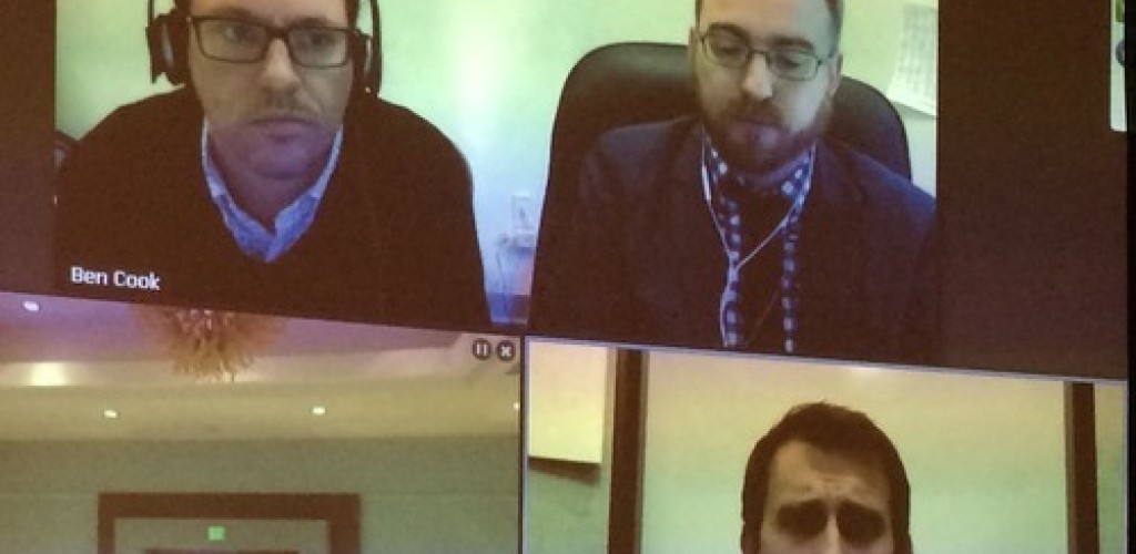 A screenshot of three men calling into a live media conference