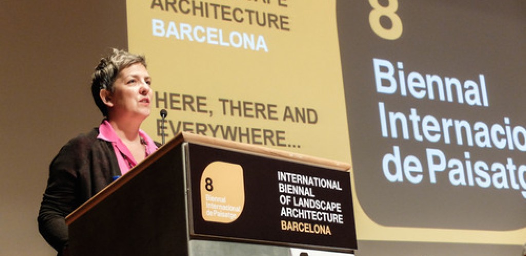 A woman gives a presentation while standing at a podium
