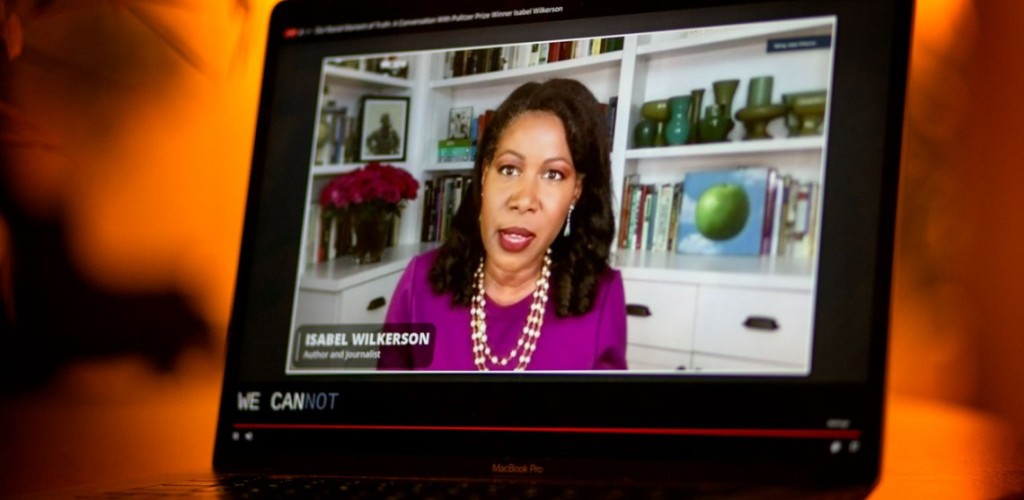 An iPad with a video playing on it of a woman speaking