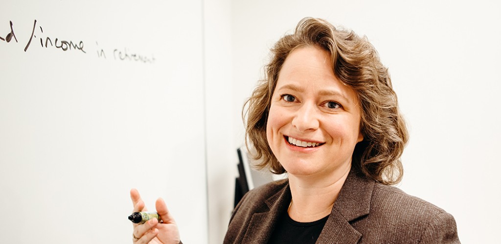 Suzanne Bliven Shu standing and talking at a white board