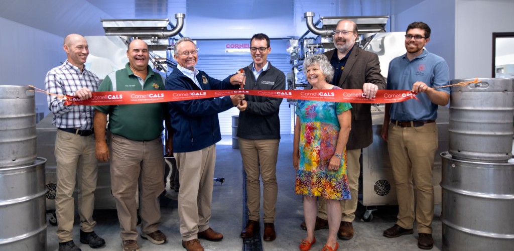Seven people participate in the Arnot facility ribbon cutting ceremony. 
