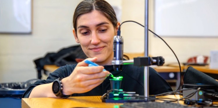 Vesna Bacheva, a postdoctoral associate in CROPPS, tests part of a prototype system designed to detect a stress response in a gene-encoded reporter plant.