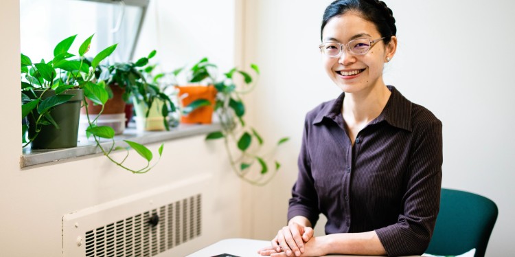 a woman sits at a table