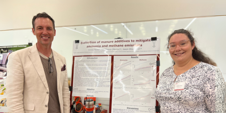 two people standing by a science poster