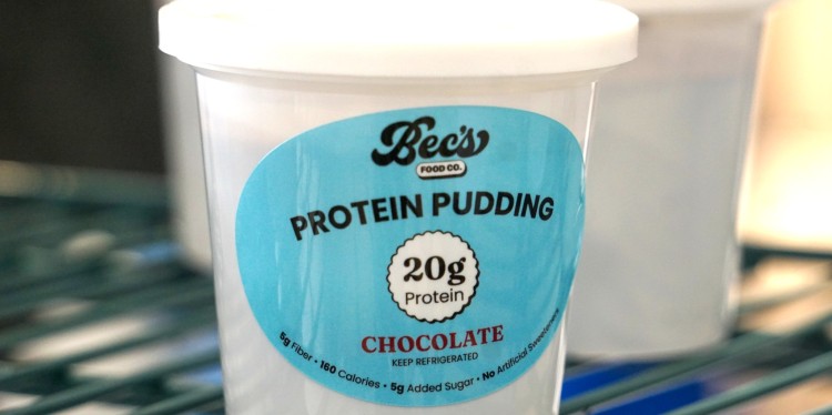 A white cup with a blue label on the side. 