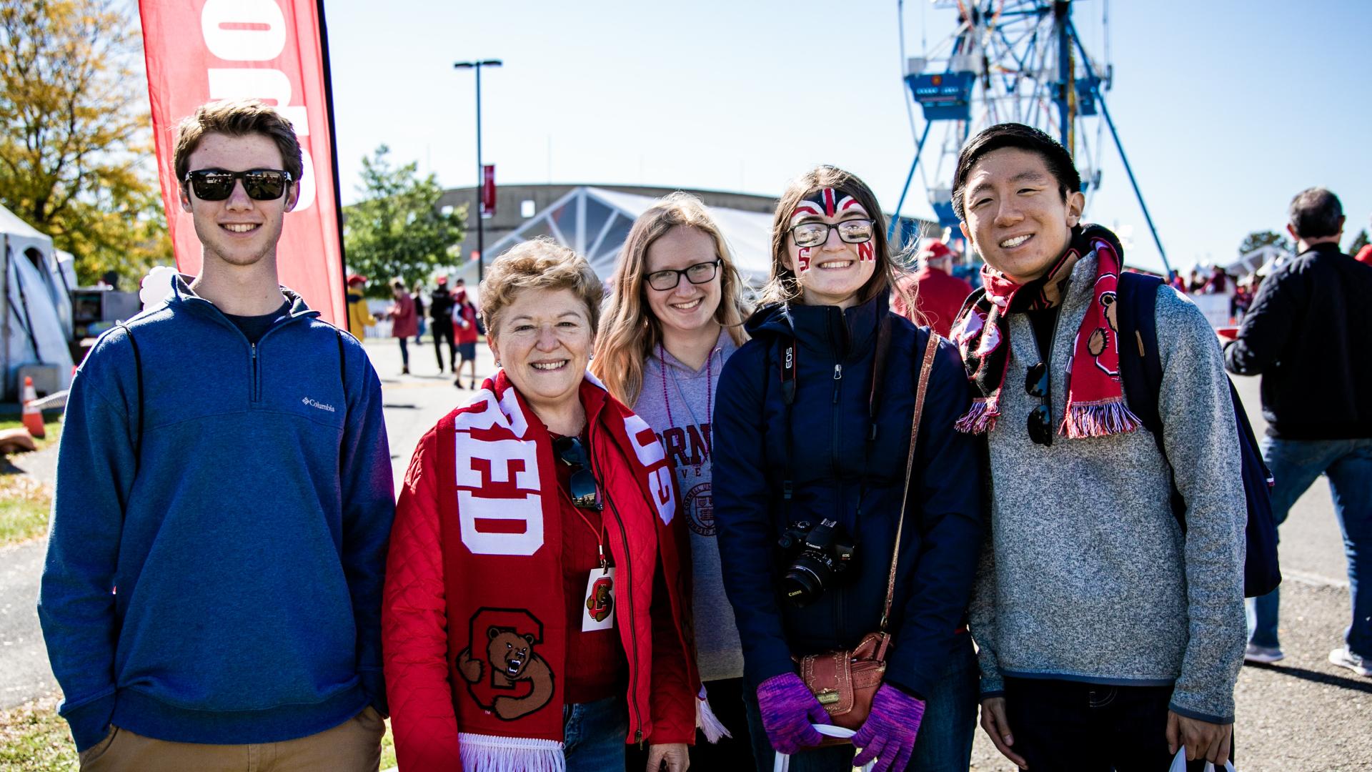 Dean Boor stands with a group of students at the 2019 Cornell Homecoming 