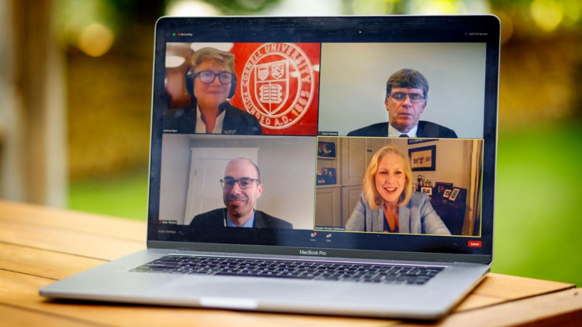 Four faces on a laptop screen