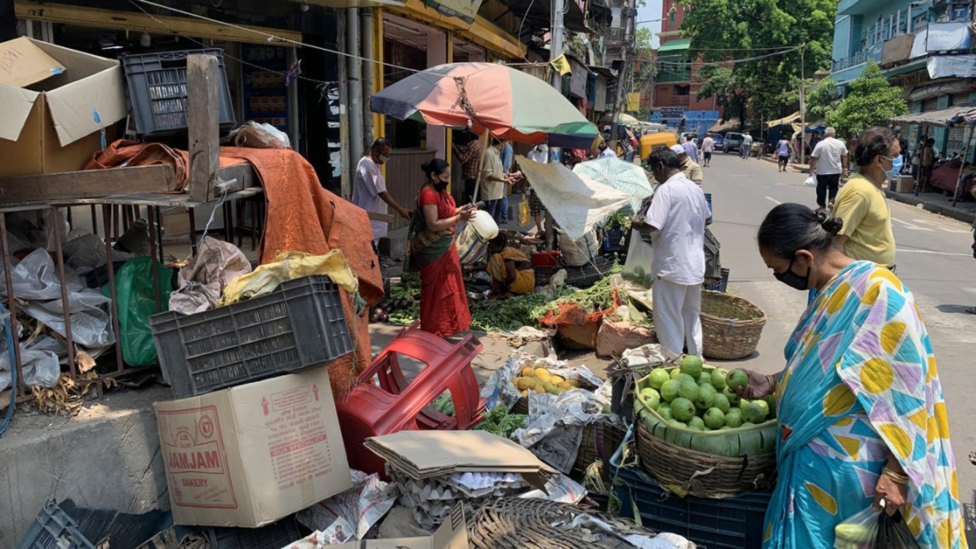 A woman shops for produce at the Shyambazar Market in Kolkata, India, during the nationwide COVID-19 lockdown in the spring.