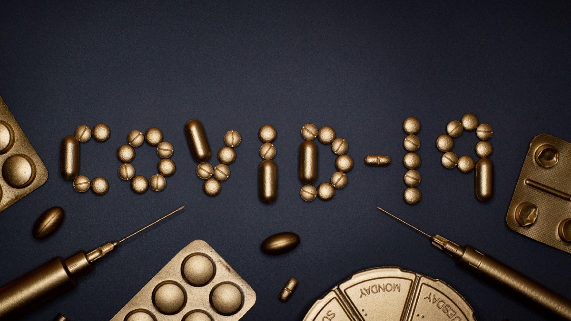 Syringe and Pills on Blue Background