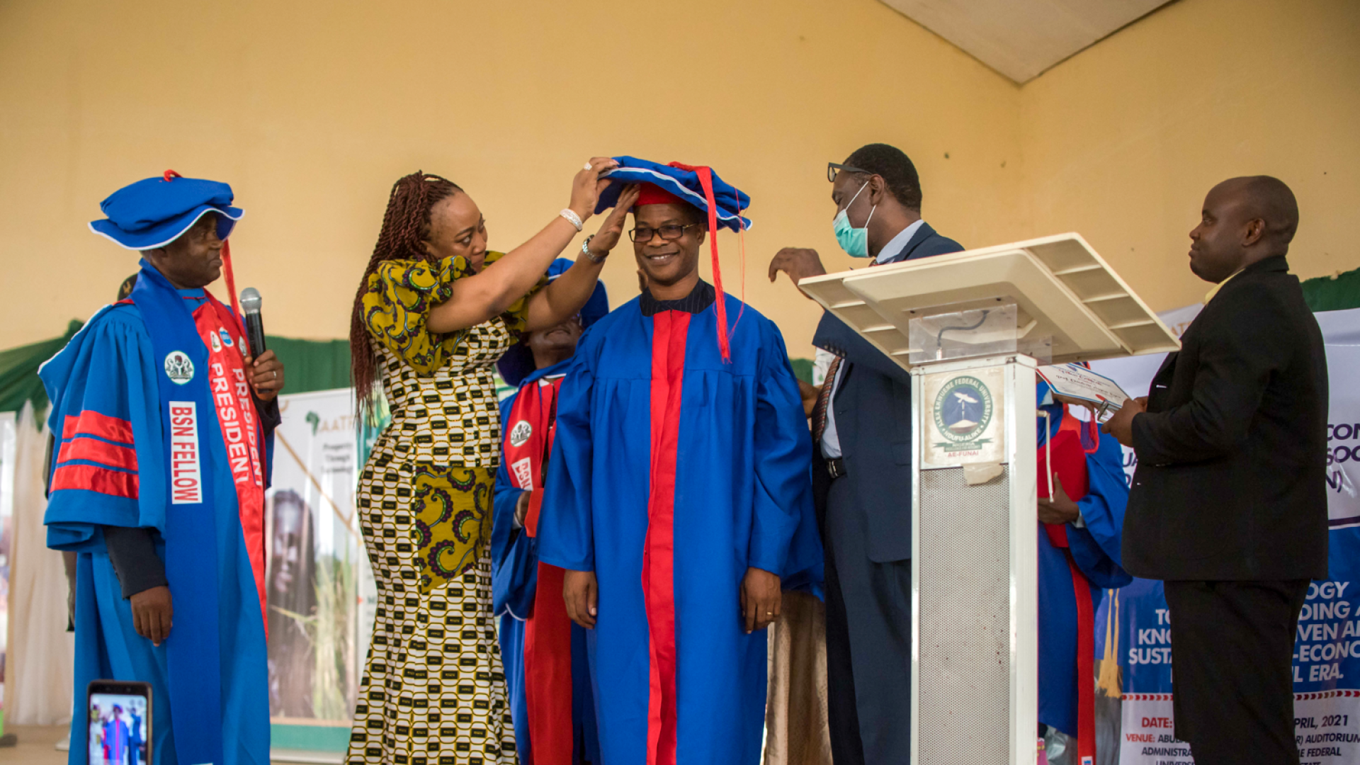 A group on stage in ceremonial robes