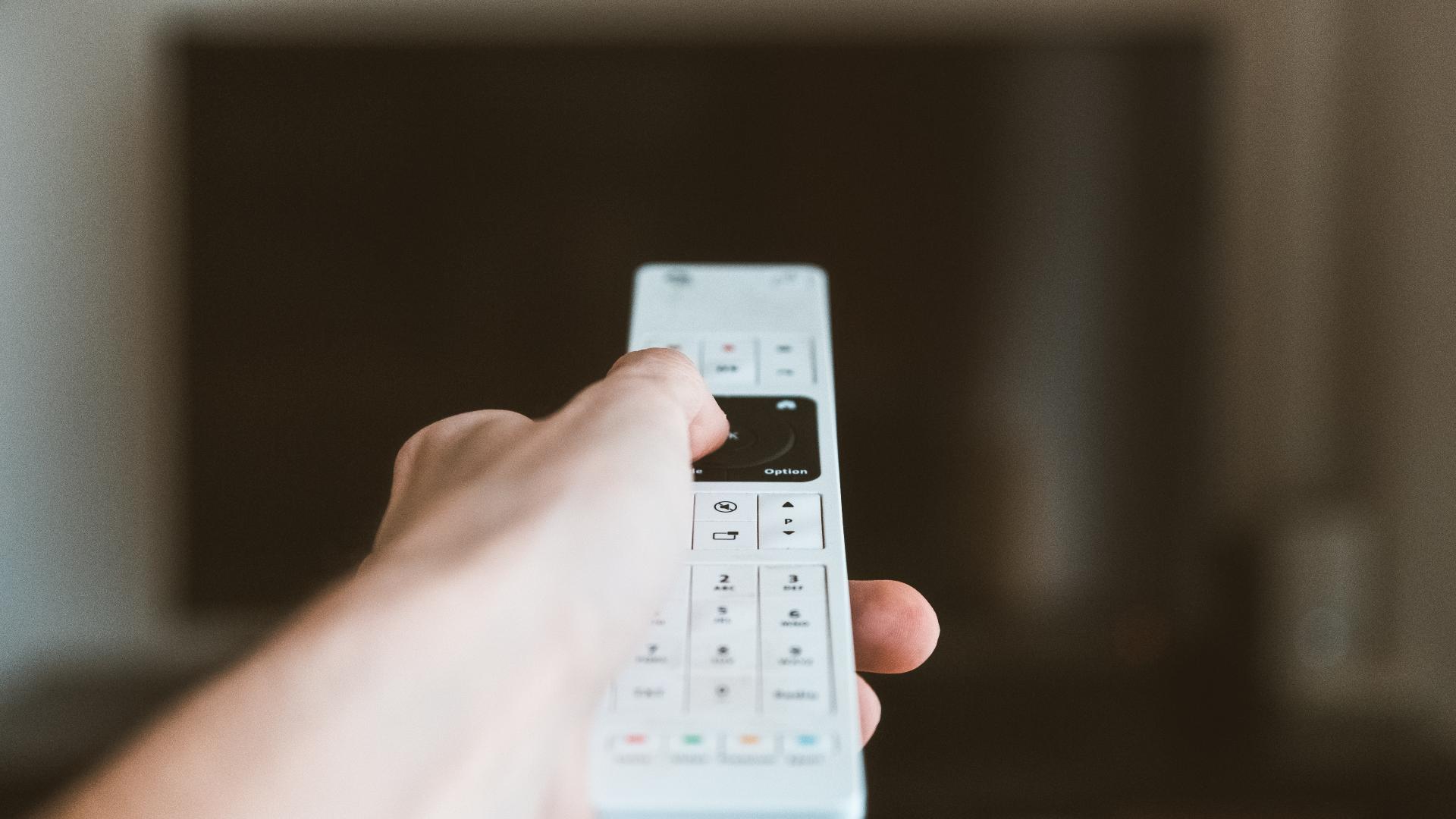 A person using a tv remote