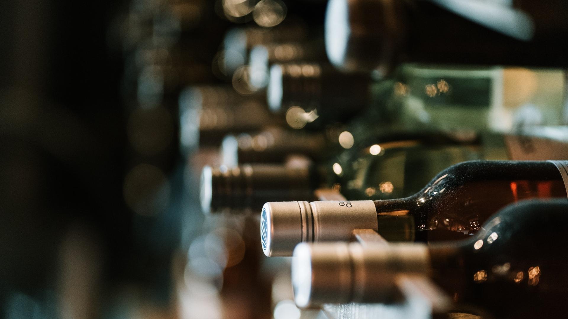 bottles of wine on a rack in a wine cellar