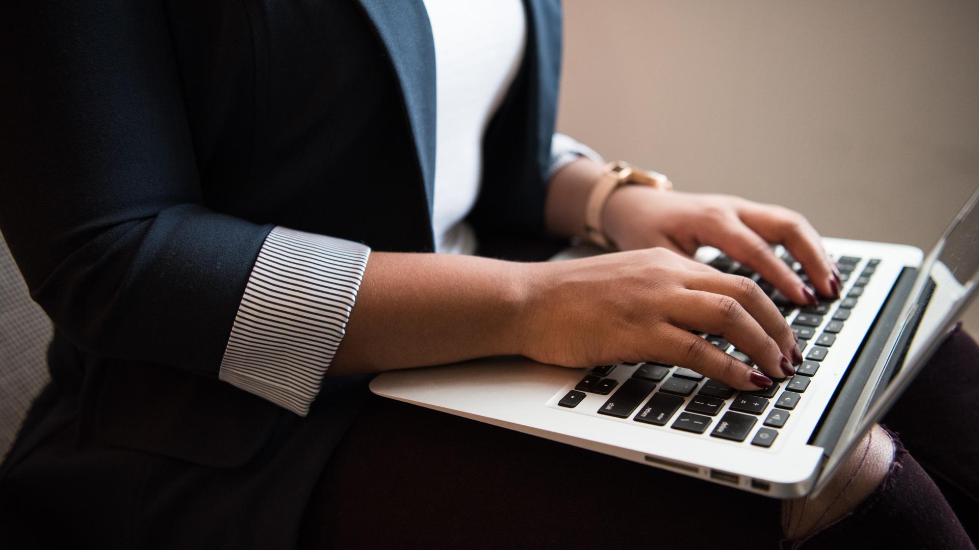 A woman working on a laptop.