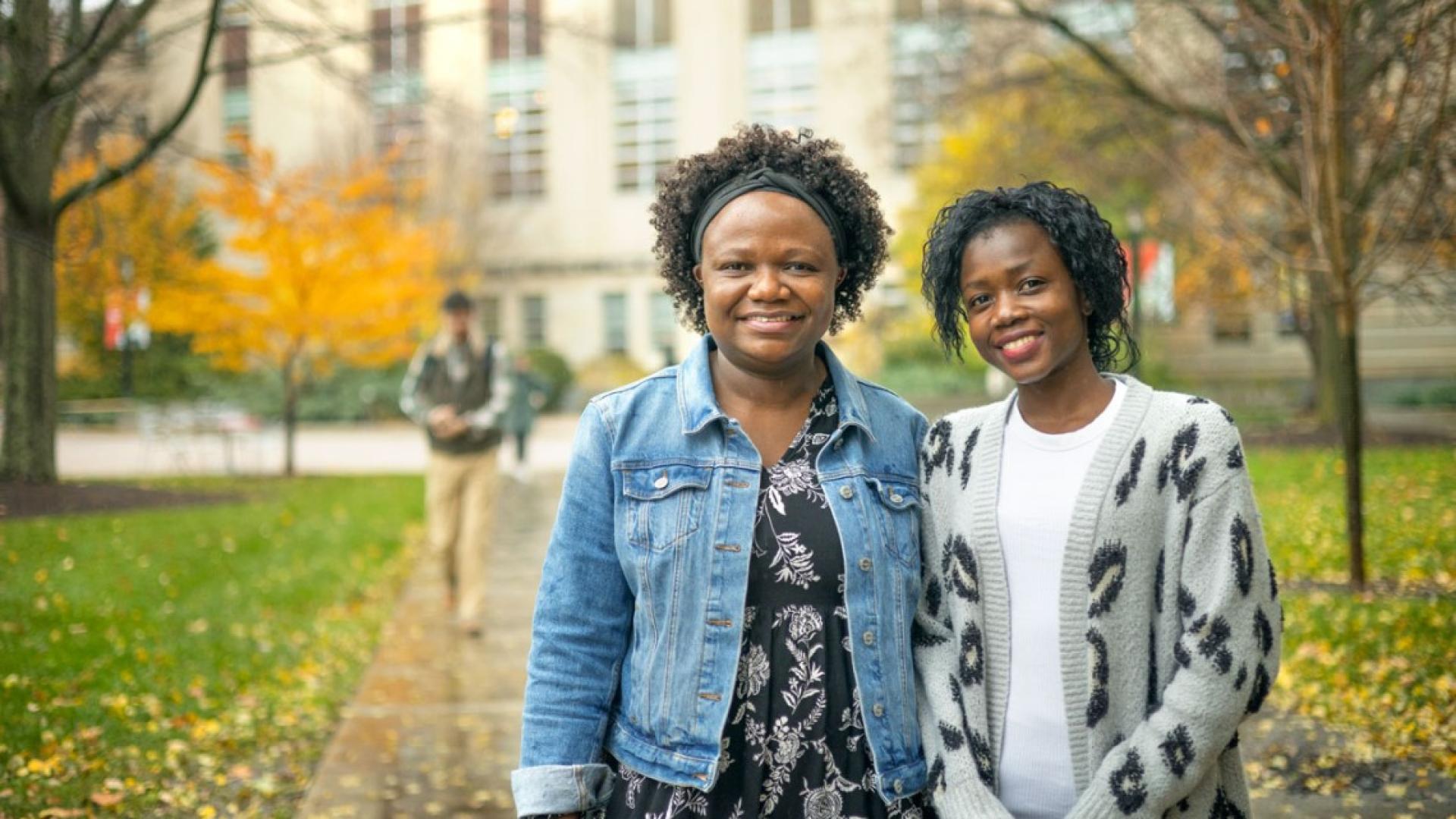 Two students stand in the Ag Quad.