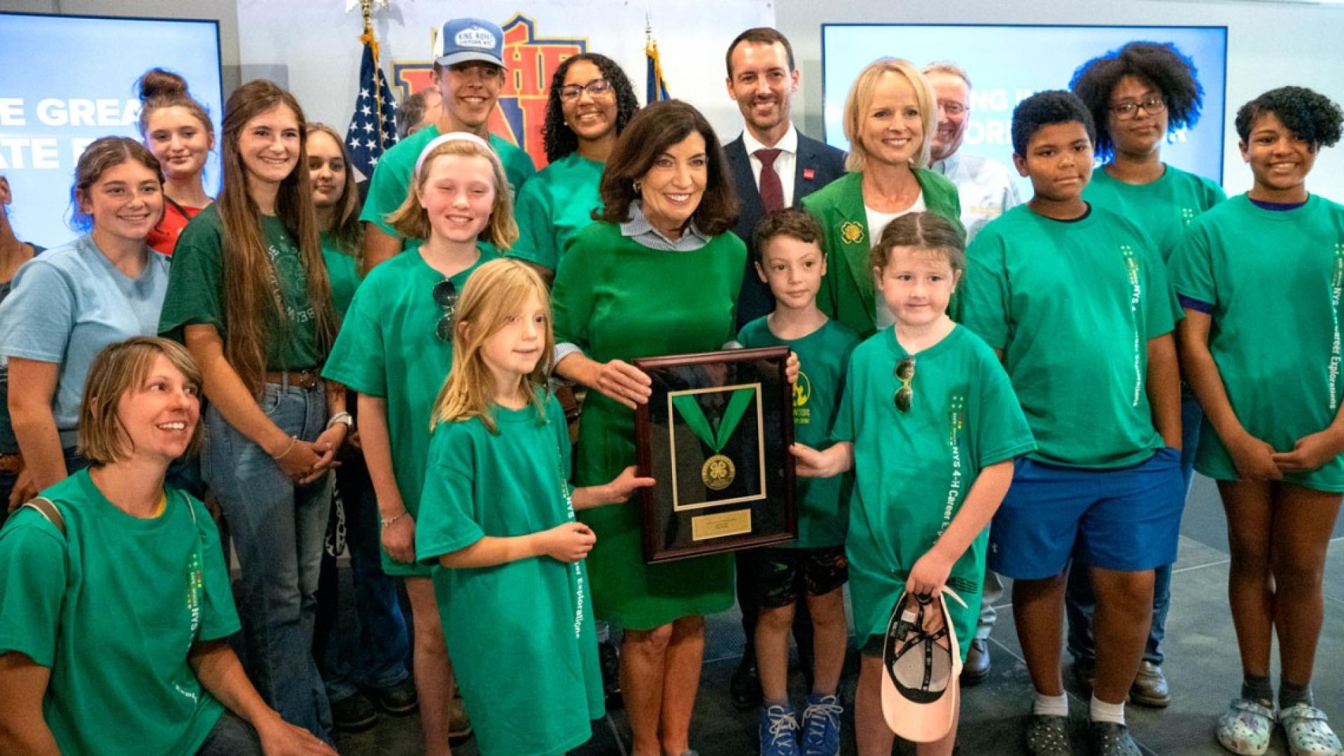 Dean Ben Houlton and Gov. Kathy Hochul stand with other 4-H members as Hochul receives her award