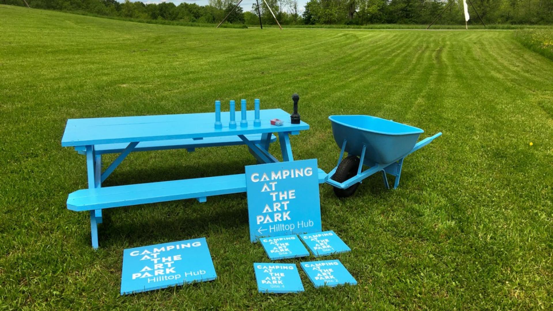 A picnic table, signage, a chair, a wheelbarrow, and even flashlights, all painted the same bright shade of blue