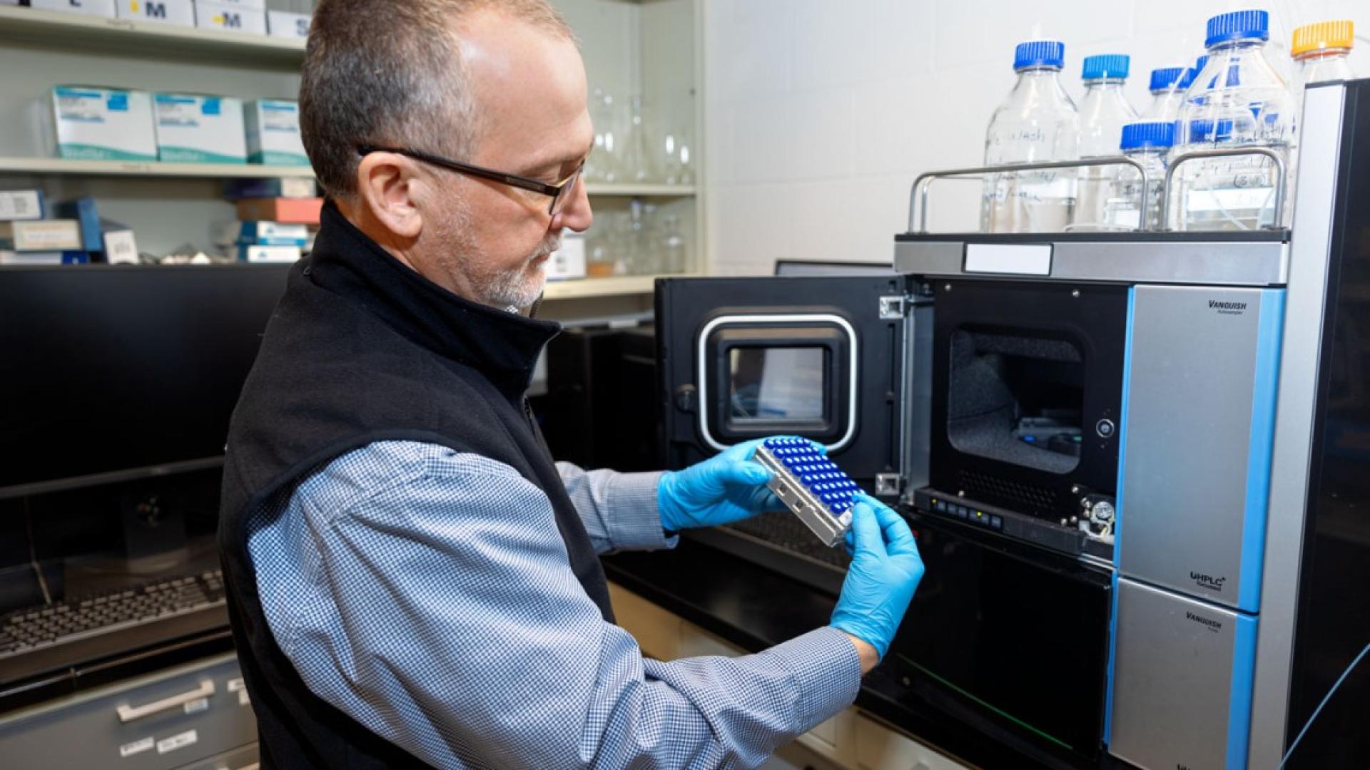 Research associate Wayne Anderson loads bee samples into a liquid chromatography mass spectrometer for analysis in the lab of Scott McArt in Comstock Hall.