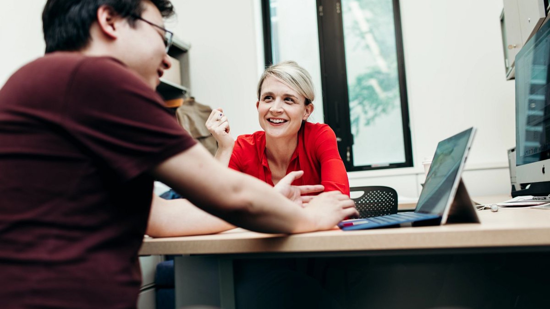 two people sitting at a desk