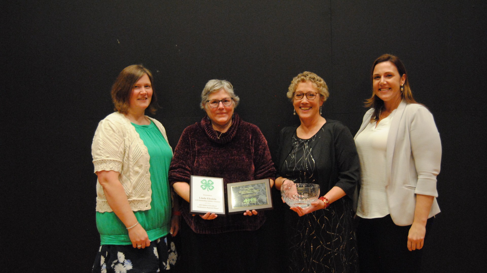 Linda Elcsisin recieving award with Alexa Maile and others