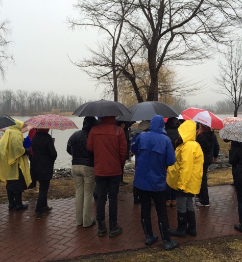 group in raincoats with umbrellas on a rainy day on the Hudson River waterfront