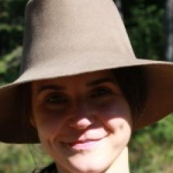 Headshot of a woman wearing a hat