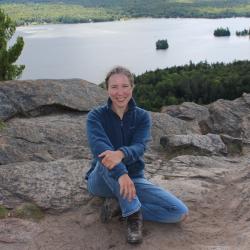 Woman sitting on shoreline