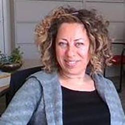 portrait of a woman in a black shirt and blue sweater