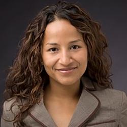 portrait of a woman in a brown suit in front of a brown wall