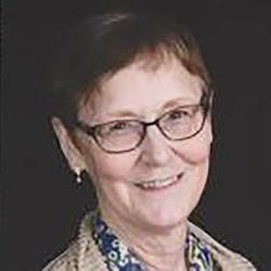 portrait of a woman in front of a black wall