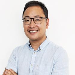 Steven Lee standing in front of white background
