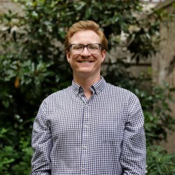 Person standing in front of a ivy wall