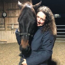 a woman hugs a horse