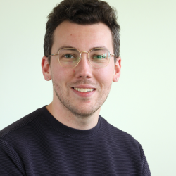 Person with brown hair and glasses