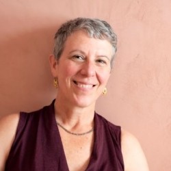 Shura in front of a peach wall