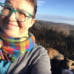 Mandy Economos outside with a long view of hills and sky