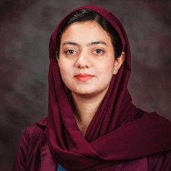 Photo of a person wearing a maroon head covering