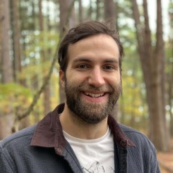 Photo of a person in front of trees