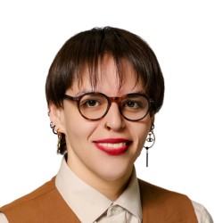 person in glasses wearing a vest