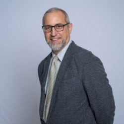 man in jacket with glasses