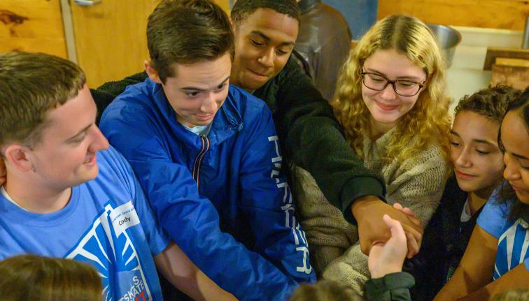 group of students doing a hands in chant