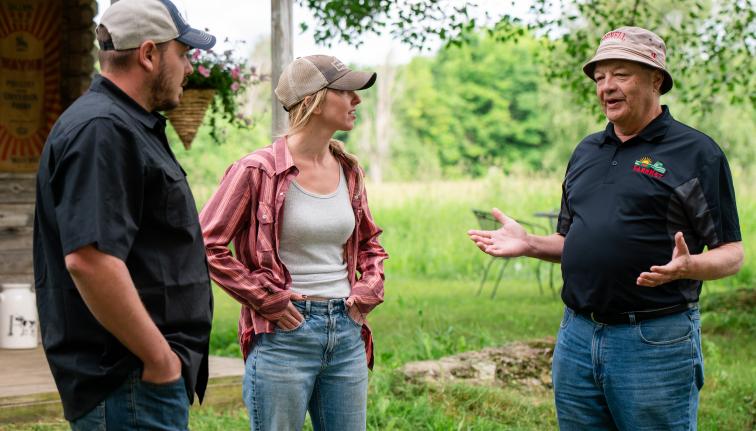 Three people talking outside